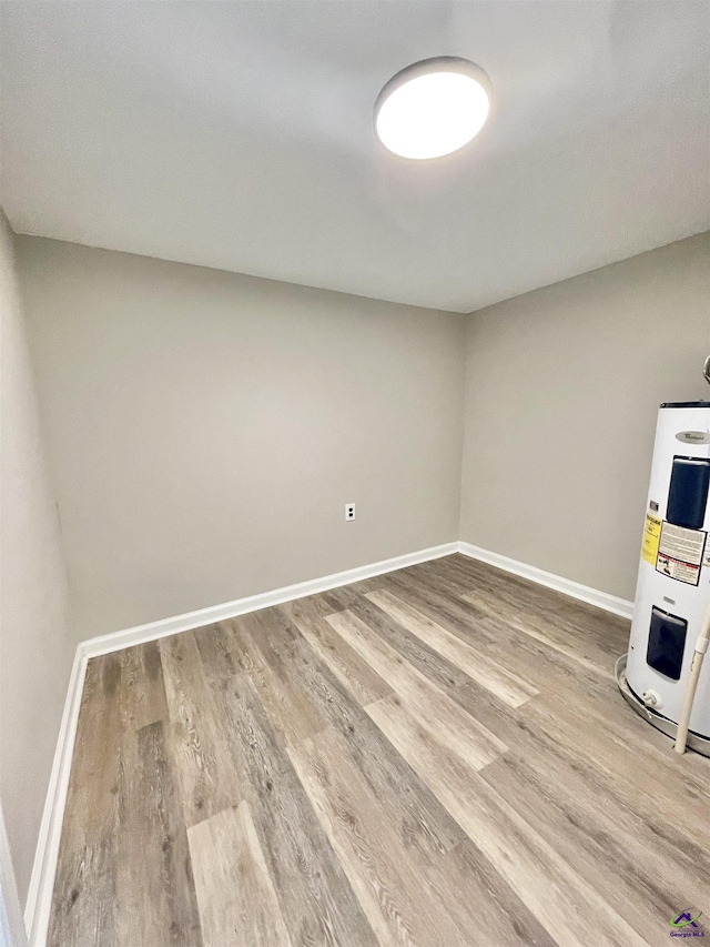 interior space with wood-type flooring and electric water heater