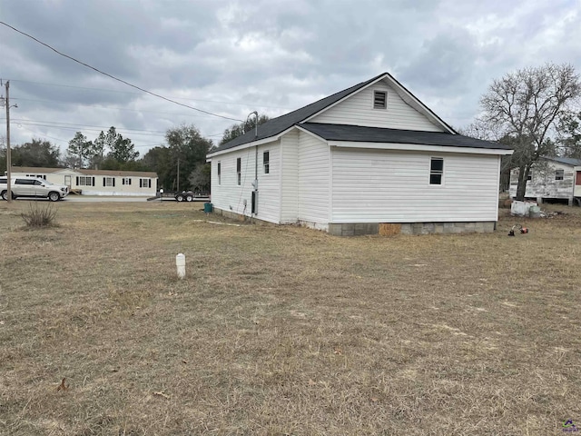 view of home's exterior featuring a yard