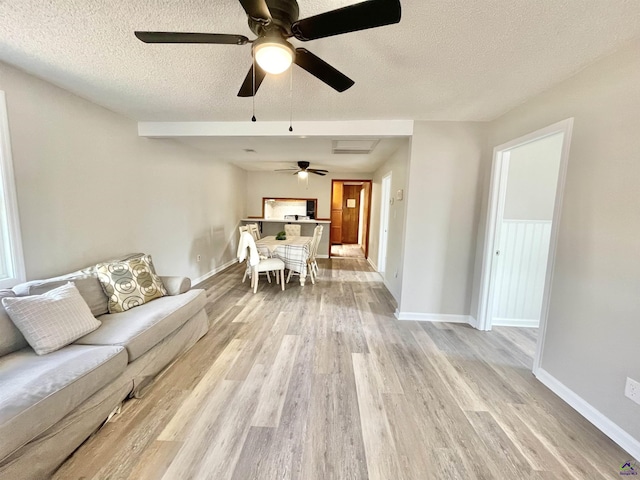 living room featuring light hardwood / wood-style flooring and a textured ceiling