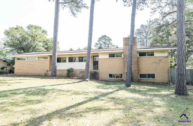 back of house with a lawn