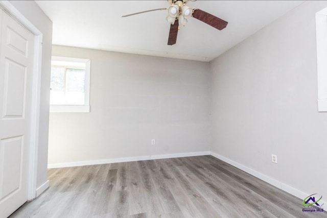 spare room featuring light hardwood / wood-style floors and ceiling fan