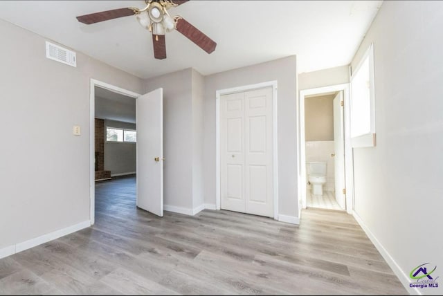 unfurnished bedroom with ceiling fan, a closet, and light hardwood / wood-style flooring