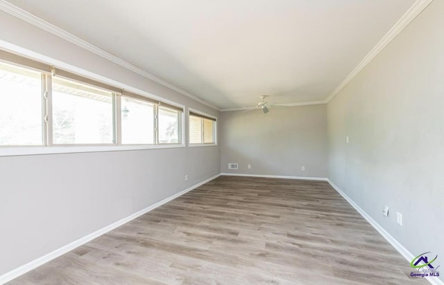 spare room featuring ornamental molding, ceiling fan, and light wood-type flooring