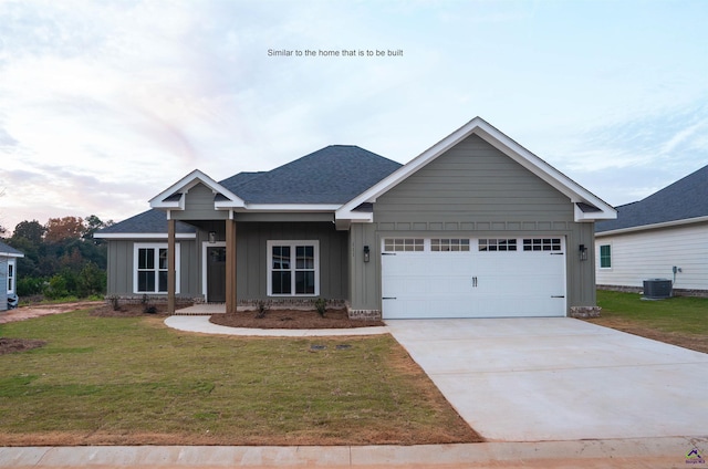 craftsman inspired home with a garage, a front lawn, and central air condition unit