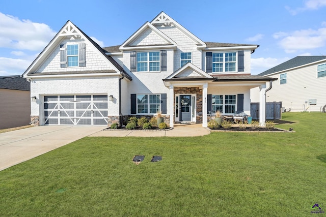 craftsman-style house with a garage, a front lawn, and covered porch