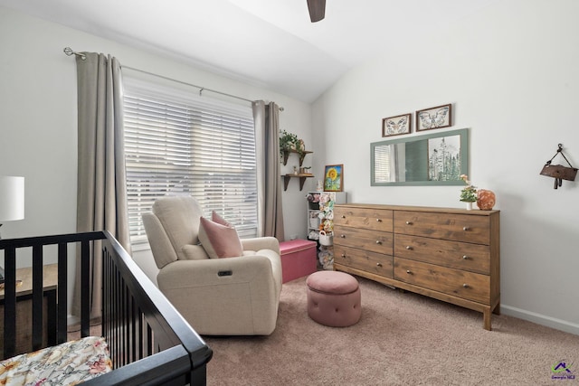 carpeted bedroom featuring a nursery area, ceiling fan, and vaulted ceiling