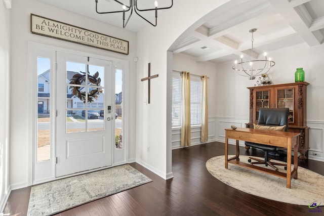 foyer entrance featuring coffered ceiling, dark wood-type flooring, a notable chandelier, and beam ceiling