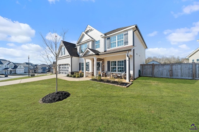 craftsman house featuring a garage and a front yard