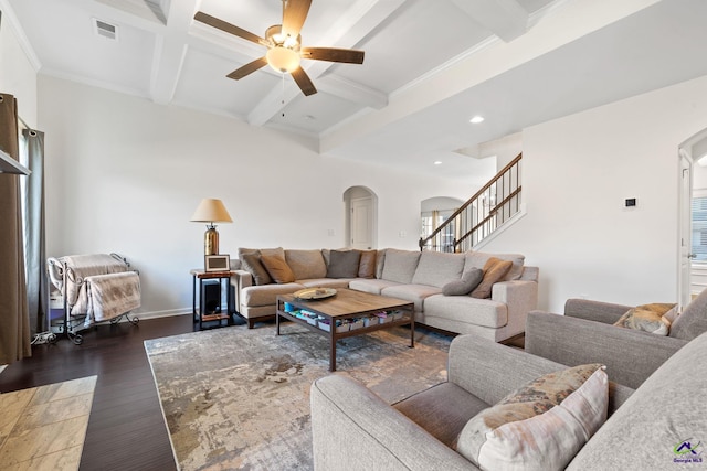 living room featuring ceiling fan, dark hardwood / wood-style floors, coffered ceiling, ornamental molding, and beamed ceiling