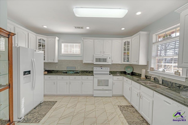 kitchen featuring sink, white cabinets, and white appliances