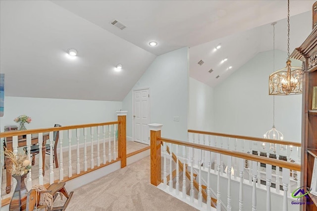 corridor with lofted ceiling, carpet flooring, and a chandelier