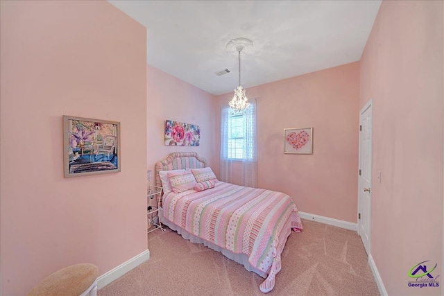 carpeted bedroom featuring a notable chandelier