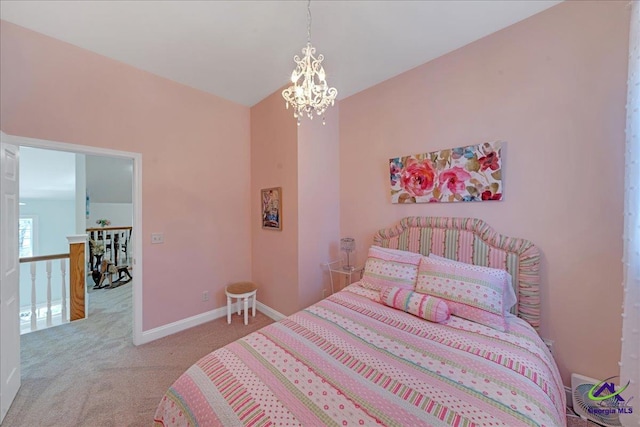 bedroom with an inviting chandelier and light carpet