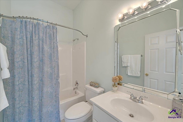 full bathroom featuring vanity, shower / bath combo with shower curtain, and toilet