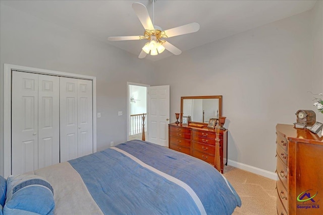 bedroom featuring light colored carpet, a closet, and ceiling fan