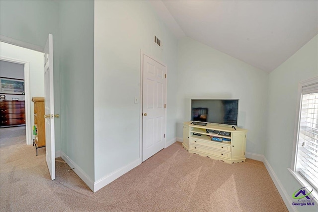 carpeted bedroom featuring lofted ceiling