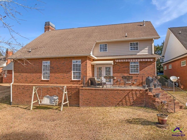 back of property featuring a lawn, french doors, and a patio area