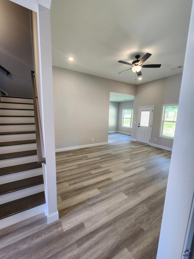 111 Silver Maple, Byron, GA 31008 - unfurnished living room featuring stairway, ceiling fan, baseboards, and wood finished floors