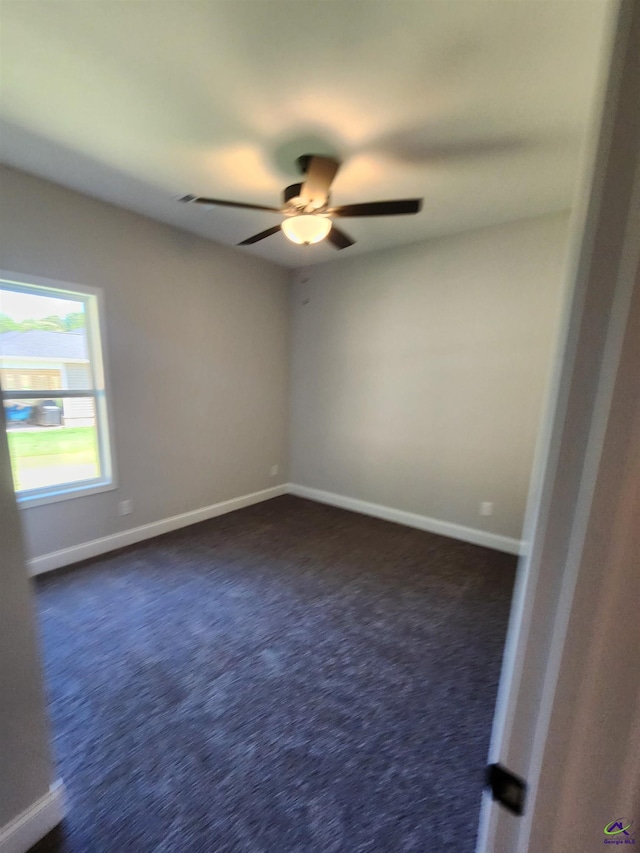 111 Silver Maple, Byron, GA 31008 - unfurnished room featuring baseboards, dark colored carpet, and a ceiling fan