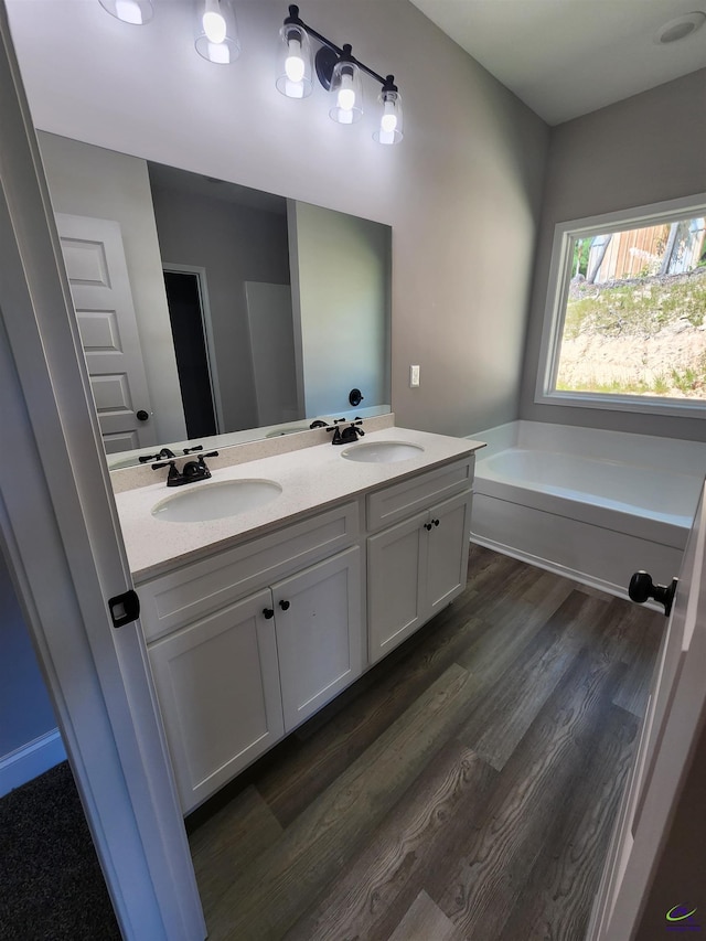 111 Silver Maple, Byron, GA 31008 - full bathroom with a garden tub, double vanity, a sink, and wood finished floors
