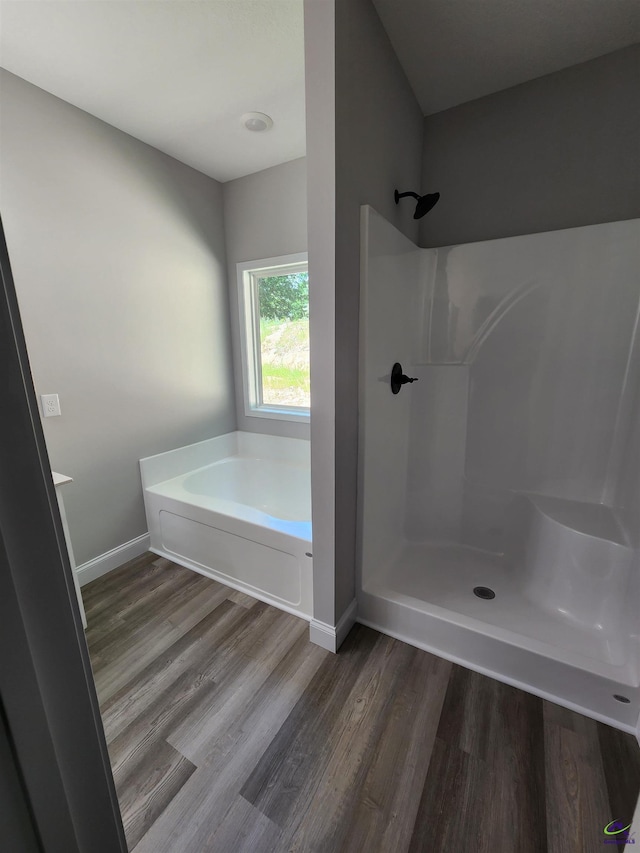 111 Silver Maple, Byron, GA 31008 - bathroom featuring walk in shower, a garden tub, wood finished floors, and baseboards