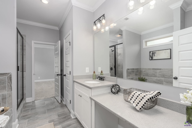 bathroom featuring an enclosed shower, crown molding, and vanity