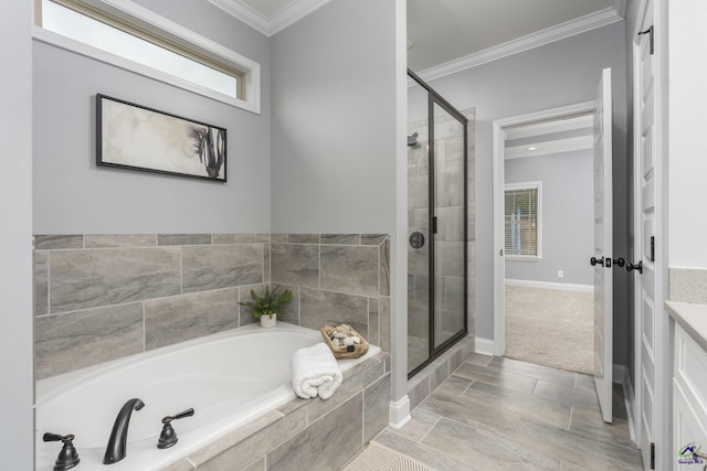 bathroom with ornamental molding, shower with separate bathtub, and vanity