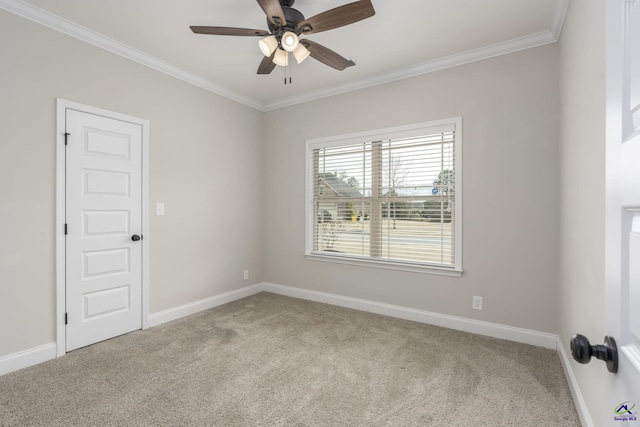 spare room with crown molding, light carpet, and ceiling fan