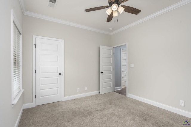 unfurnished bedroom with crown molding, carpet flooring, and ceiling fan