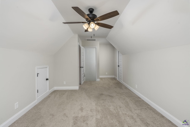 bonus room featuring ceiling fan, light colored carpet, and vaulted ceiling