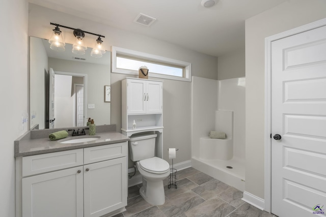 bathroom featuring walk in shower, vanity, and toilet