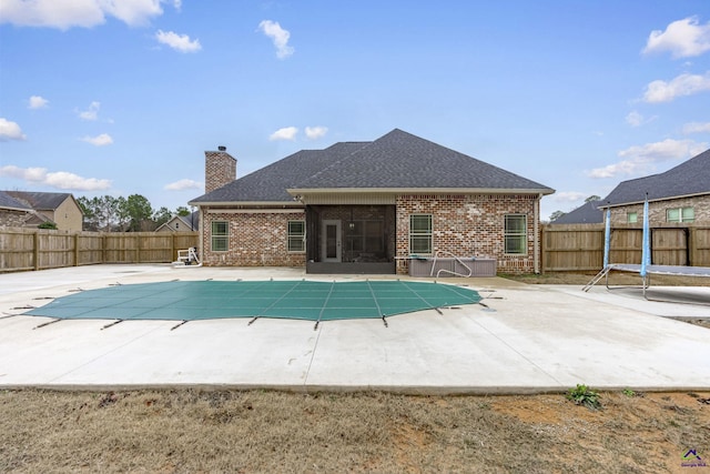 view of pool with a sunroom and a patio area