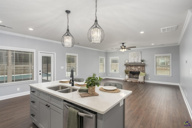 kitchen with sink, hanging light fixtures, a center island with sink, stainless steel dishwasher, and gray cabinets