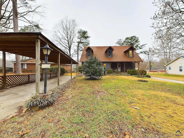 view of front of house with a front yard, fence, driveway, and a chimney