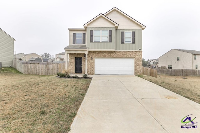 view of front of property with a front yard and a garage