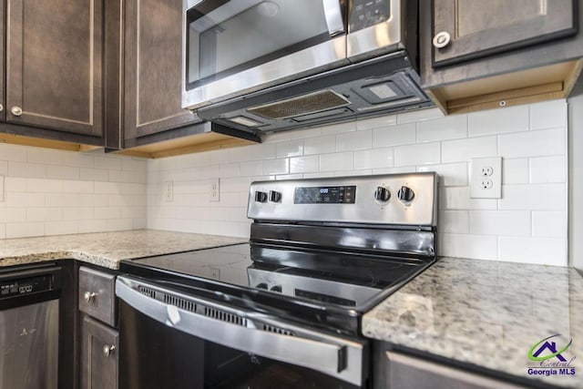 kitchen featuring appliances with stainless steel finishes, tasteful backsplash, dark brown cabinetry, and light stone countertops