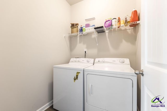 washroom with washing machine and clothes dryer