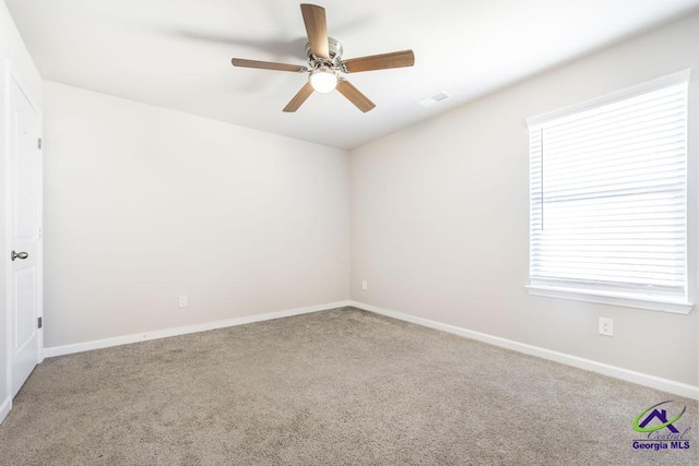 unfurnished room featuring ceiling fan and carpet