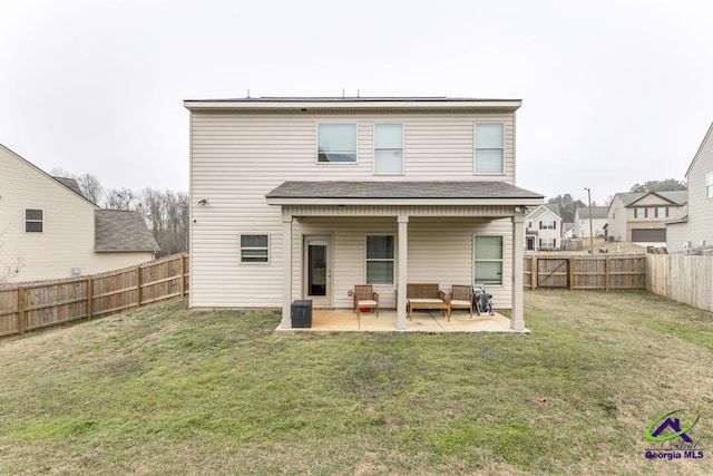 rear view of property with a patio area and a lawn