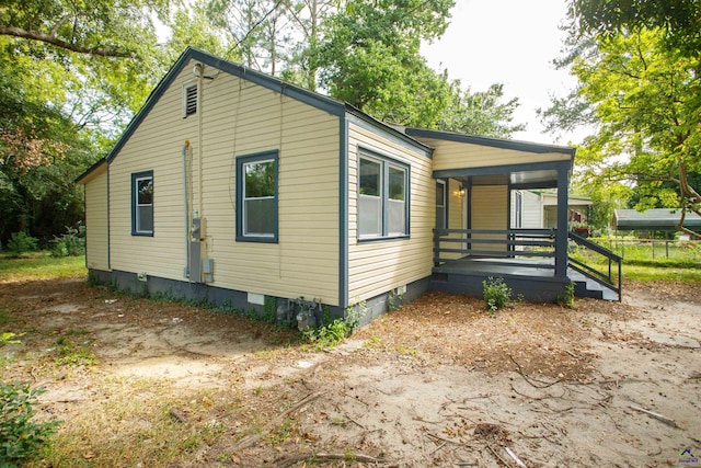 view of side of property featuring a porch