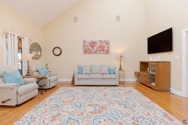 living room featuring hardwood / wood-style flooring and high vaulted ceiling