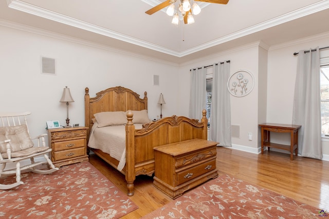 bedroom with ceiling fan, ornamental molding, and hardwood / wood-style floors