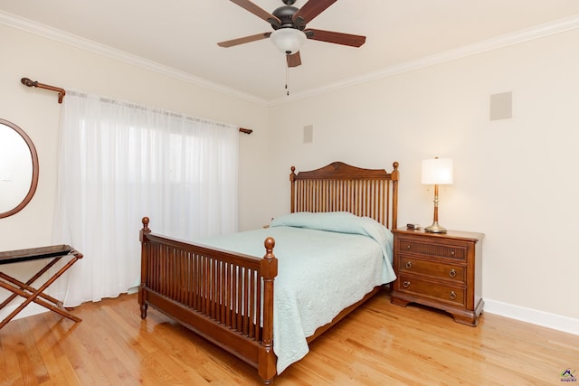 bedroom featuring ceiling fan, ornamental molding, and hardwood / wood-style floors