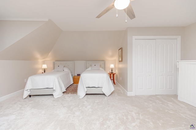 carpeted bedroom with lofted ceiling, ceiling fan, and a closet