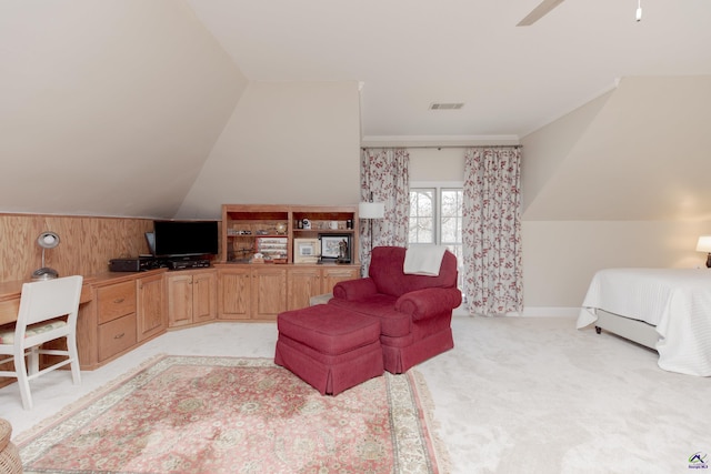 carpeted living room with ceiling fan and vaulted ceiling