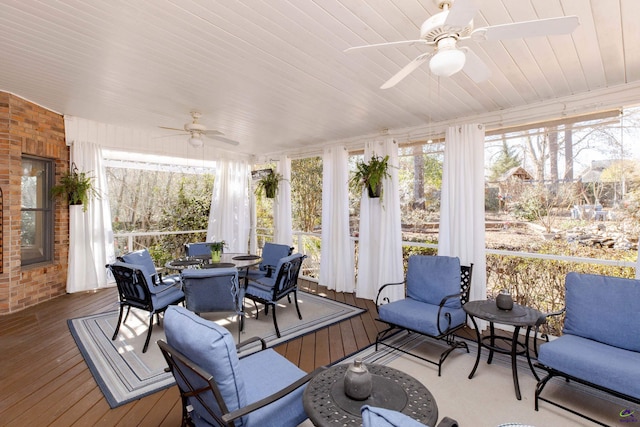 sunroom featuring ceiling fan