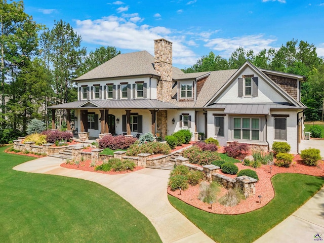 view of front of home featuring covered porch and a front lawn