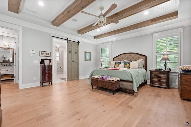 bedroom featuring multiple windows, a barn door, beamed ceiling, and light hardwood / wood-style flooring