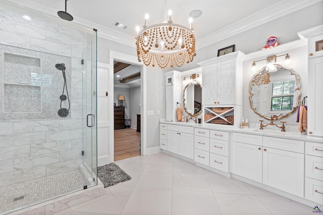 bathroom with tile patterned floors, an enclosed shower, crown molding, an inviting chandelier, and vanity