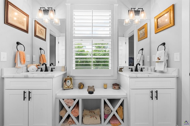 bar featuring white cabinetry, sink, and light stone counters